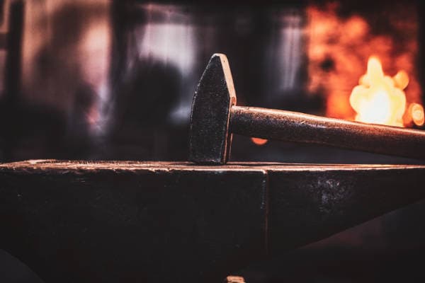 Traditional blacksmith forge with fire representing the Spire Forge artisan web studio process.